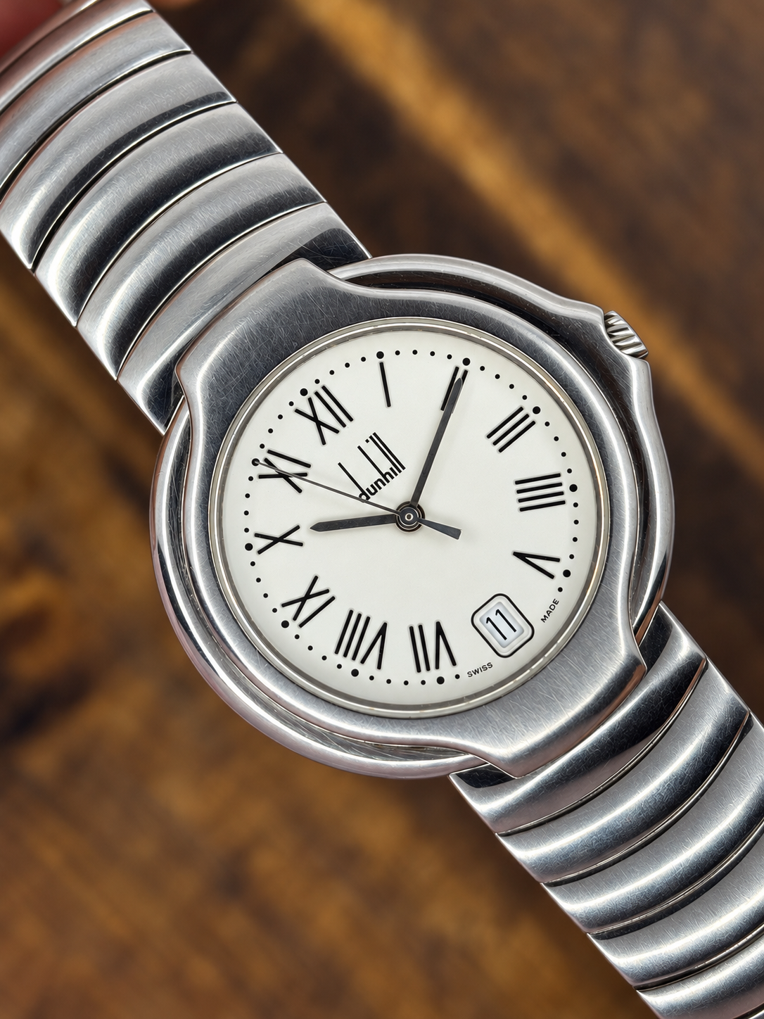 Vintage Dunhill Stainless Steel watch with white Roman numeral dial and integrated silver-tone bracelet