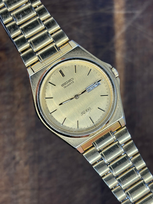 Seiko SQ100 Day-Date – Gold Dial & Bracelet