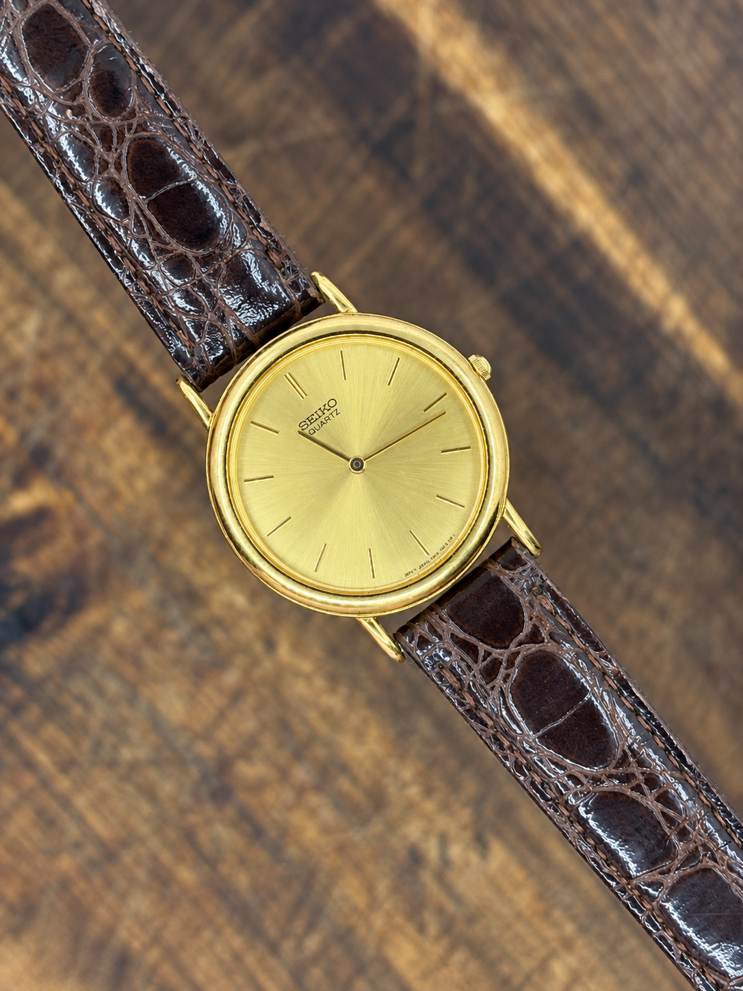 Vintage Seiko Quartz Gold-Tone Round Dress watch with champagne dial and black crocodile-pattern leather strap